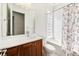 Clean bathroom with wood vanity, tub, and glass block window at 12161 Obelia Ln, Orlando, FL 32827