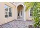 Front entry with arched detail and terracotta tile flooring at 12161 Obelia Ln, Orlando, FL 32827