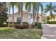 Beautiful one-story home with a brick driveway, lush landscaping, and a tile roof at 12161 Obelia Ln, Orlando, FL 32827