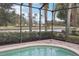 Relaxing screened pool with view of a peaceful lake and lush landscape at 12161 Obelia Ln, Orlando, FL 32827