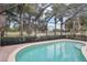 Inviting pool area with screened enclosure and tranquil water view at 12161 Obelia Ln, Orlando, FL 32827