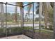 Enjoy the peaceful lake view from the screened pool area at 12161 Obelia Ln, Orlando, FL 32827