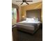 Spacious bedroom with king-size bed and ceiling fan at 12539 Floridays Resort Dr # 210D, Orlando, FL 32821