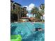 Resort-style pool with palm trees and ample space for relaxation at 12539 Floridays Resort Dr # 210D, Orlando, FL 32821