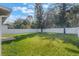 Green backyard with a white fence at 131 Bristol Forest Trl, Sanford, FL 32771