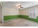 Bedroom with green walls, ceiling fan and window at 131 Bristol Forest Trl, Sanford, FL 32771