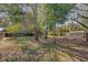 Large backyard with mature trees and a wooden fence at 145 Verbena Dr, Orlando, FL 32807