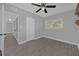 Bedroom with ceiling fan, window, and wood-look tile floors at 145 Verbena Dr, Orlando, FL 32807