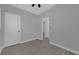 Simple bedroom with ceiling fan and wood-look tile floor at 145 Verbena Dr, Orlando, FL 32807