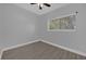 Bright bedroom with window, ceiling fan, and wood-look tile floor at 145 Verbena Dr, Orlando, FL 32807