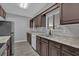 Modern kitchen with dark brown cabinets and stainless steel appliances at 145 Verbena Dr, Orlando, FL 32807