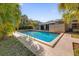 Relaxing rectangular pool, surrounded by lush tropical foliage at 145 Verbena Dr, Orlando, FL 32807