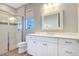 Simple bathroom with white vanity and shower at 15550 Avenue Of The Arbors, Winter Garden, FL 34787