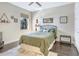 Guest bedroom with green bedding and dark wood floors at 15550 Avenue Of The Arbors, Winter Garden, FL 34787