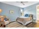 Cozy bedroom with light blue walls and ceiling fan at 15550 Avenue Of The Arbors, Winter Garden, FL 34787