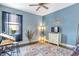 Blue bedroom with a large area rug and ceiling fan at 15550 Avenue Of The Arbors, Winter Garden, FL 34787