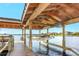 Covered dock with a boat lift for convenient water access at 15550 Avenue Of The Arbors, Winter Garden, FL 34787