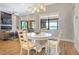 Charming dining area with white table and chairs, overlooking the water at 15550 Avenue Of The Arbors, Winter Garden, FL 34787