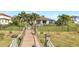 Wooden bridge dock with rope railings leading to a house at 15550 Avenue Of The Arbors, Winter Garden, FL 34787