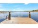 Lakefront dock with a swimming ladder and tranquil water views at 15550 Avenue Of The Arbors, Winter Garden, FL 34787