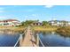 Wooden walkway dock leads to a waterfront home at 15550 Avenue Of The Arbors, Winter Garden, FL 34787