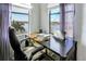 Home office features a large desk, two windows with lake view, and comfortable chair at 15550 Avenue Of The Arbors, Winter Garden, FL 34787