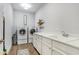 Bright laundry room features washer, dryer, and ample counter space at 15550 Avenue Of The Arbors, Winter Garden, FL 34787