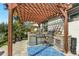 Outdoor kitchen with pergola, grill, and sink at 15550 Avenue Of The Arbors, Winter Garden, FL 34787