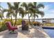 Firepit and seating area on a spacious patio with lake view at 15550 Avenue Of The Arbors, Winter Garden, FL 34787