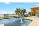 Relaxing pool and spa with a lake view and pergola at 15550 Avenue Of The Arbors, Winter Garden, FL 34787