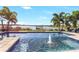 Inviting pool with water feature and serene lake view at 15550 Avenue Of The Arbors, Winter Garden, FL 34787