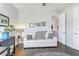 Cozy sitting room with white sofa and dark wood floors at 15550 Avenue Of The Arbors, Winter Garden, FL 34787