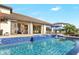 Inviting swimming pool with tiled decking and water feature at 15550 Avenue Of The Arbors, Winter Garden, FL 34787