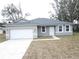 Newly constructed home with gray exterior, white garage door, and landscaping at 16391 Sw 17Th Terrace Rd, Ocala, FL 34473