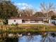 House exterior view with screen porch and lake view at 1818 Foxboro Dr, Orlando, FL 32812