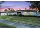 Ranch-style home with landscaped lawn and sunset view at 1818 Foxboro Dr, Orlando, FL 32812