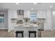 Modern kitchen with white cabinets, granite island, and stainless steel appliances at 1818 Foxboro Dr, Orlando, FL 32812