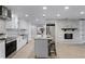 Modern kitchen with white cabinets, granite island, and stainless steel appliances at 1818 Foxboro Dr, Orlando, FL 32812