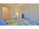 Bright bedroom with a queen bed, closet, and access to a hallway at 1890 Silver Fern Dr, Port Orange, FL 32128