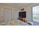 Bedroom with a queen bed, large closet, and window overlooking the yard at 1890 Silver Fern Dr, Port Orange, FL 32128