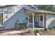 Front entryway of a gray house with a screen door and landscaping at 1890 Silver Fern Dr, Port Orange, FL 32128