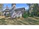 Gray single-story home with a chimney and backyard view at 1890 Silver Fern Dr, Port Orange, FL 32128