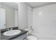 Clean bathroom with single vanity, shower/tub combo, and white tile at 2025 Havasu Falls Ave, Deland, FL 32724