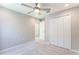 Bedroom featuring a ceiling fan, double door closet, and neutral decor at 2025 Havasu Falls Ave, Deland, FL 32724