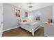 Bedroom with white bed frame and colorful artwork at 206 Aberdeen Street St, Davenport, FL 33896