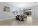 Dining area with farmhouse table, bench seating, and sliding glass doors to backyard at 206 Aberdeen Street St, Davenport, FL 33896