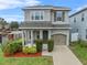 Two-story house with gray siding, landscaping, and a two-car garage at 206 Aberdeen Street St, Davenport, FL 33896