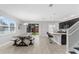 Modern kitchen with dark cabinets, granite counters, and a farmhouse dining table at 206 Aberdeen Street St, Davenport, FL 33896