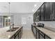 Kitchen features dark cabinets, granite countertops, and a large stainless steel sink at 206 Aberdeen Street St, Davenport, FL 33896