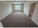 Carpeted bedroom boasts ample space and a window with bright, natural light at 2212 Lake Preserve Cir, New Smyrna Beach, FL 32168